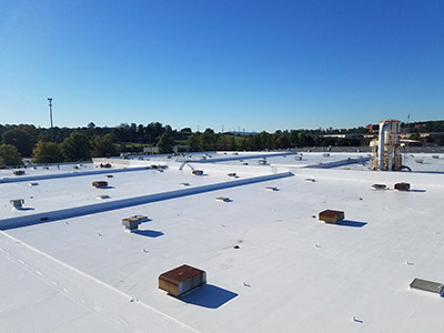 A white commercial roofing with an Alphaguard coating.