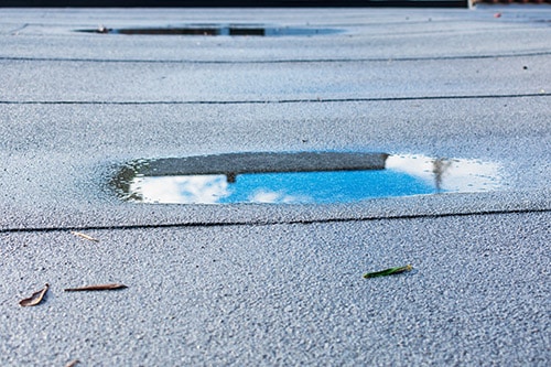 Ponding water on the top of a flat roof.