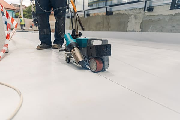 A hot air welder fixing seams on a PVC roof.