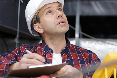 Roofing contractor inspecting a roof