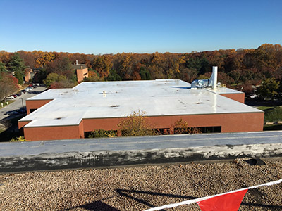 A commercial building with a white TPO roof.