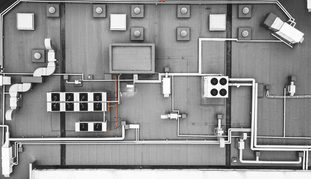 A top-down view of an industrial roof, including the HVAC and venting systems