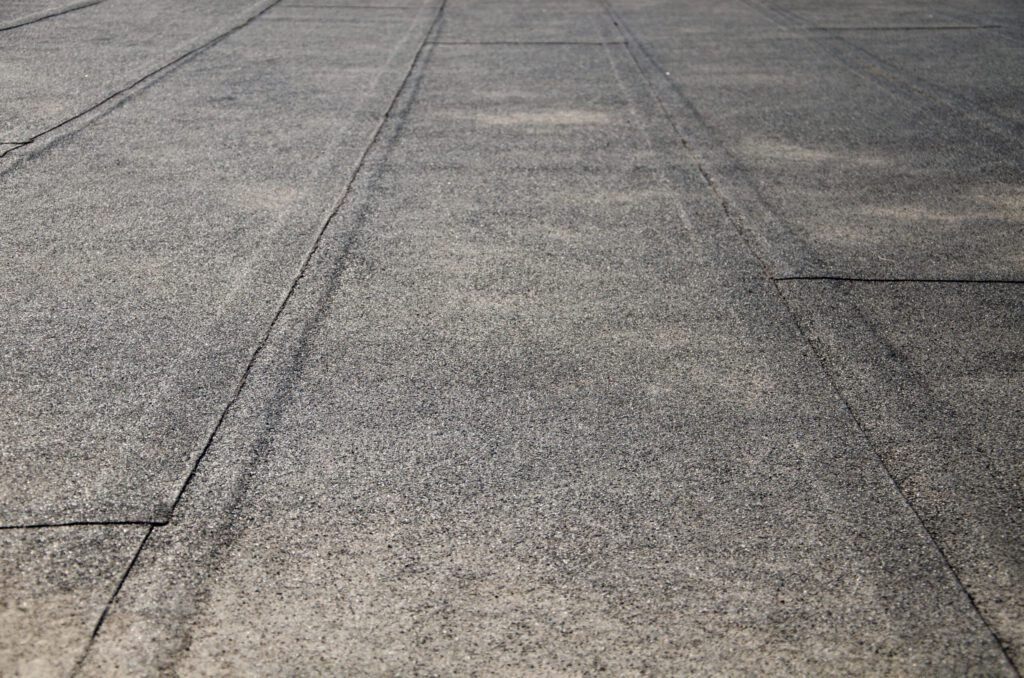 A flat roof covered in bitumen sheets.