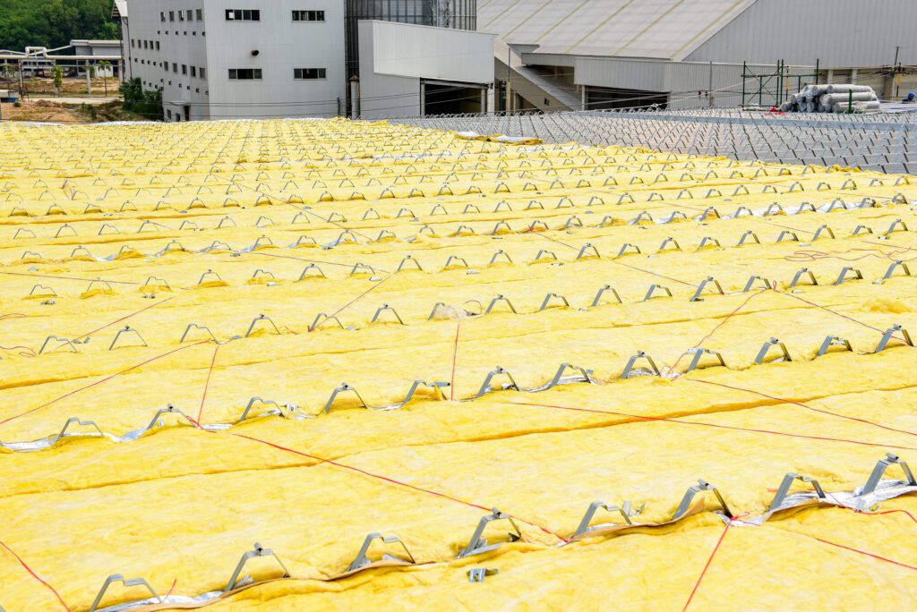Yellow insulation on a commercial roof before the roofing material is installed.