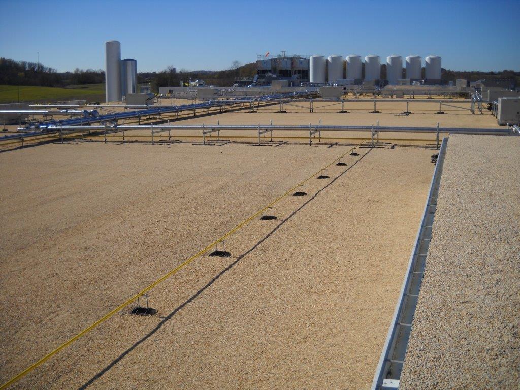 A commercial flat roof with built-up roofing material.